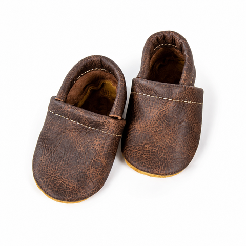 Top-left dark brown shoes isolated on a white background